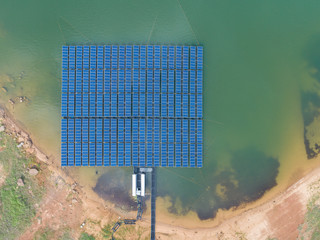 Aerial top view of Floating Solar Energy Panels on a lake - solar power farms.