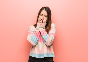 Wall Mural - Young cute woman laughing about something, covering mouth with hands