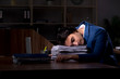 © Elnur - Young male employee working night in the office