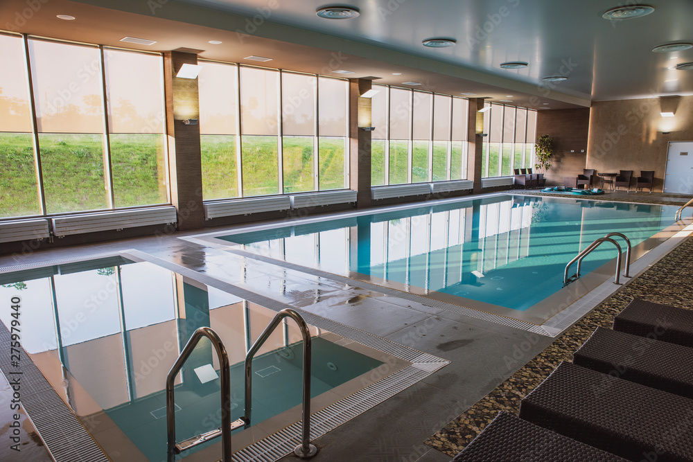 beautiful indoor pool with Jacuzzi with rattan furniture and large ...