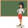 Young female teacher gestures in front of a traditional blackboard.