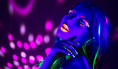 Wall Mural - Fashion disco woman. Dancing model in neon light, portrait of beauty girl with fluorescent makeup. Art design