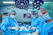 © Georgii - A surgeon's team in uniform performs an operation on a patient at a cardiac surgery clinic. Modern medicine, a professional team of surgeons, health.