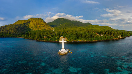 Wall Mural - Aerial panorama of the Sunken Cemetery and background volcanos in the evening light on Camiguin Island, Philippines