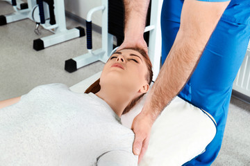 Wall Mural - Physiotherapist working with patient in rehabilitation center