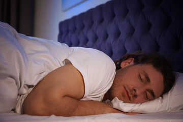 Sticker - Handsome young man sleeping on pillow at night. Bedtime