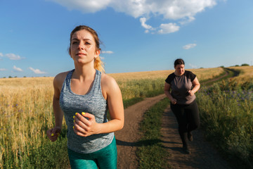 Overweight woman has short breath at outdoor jogging workout. Fitness, sports and health care