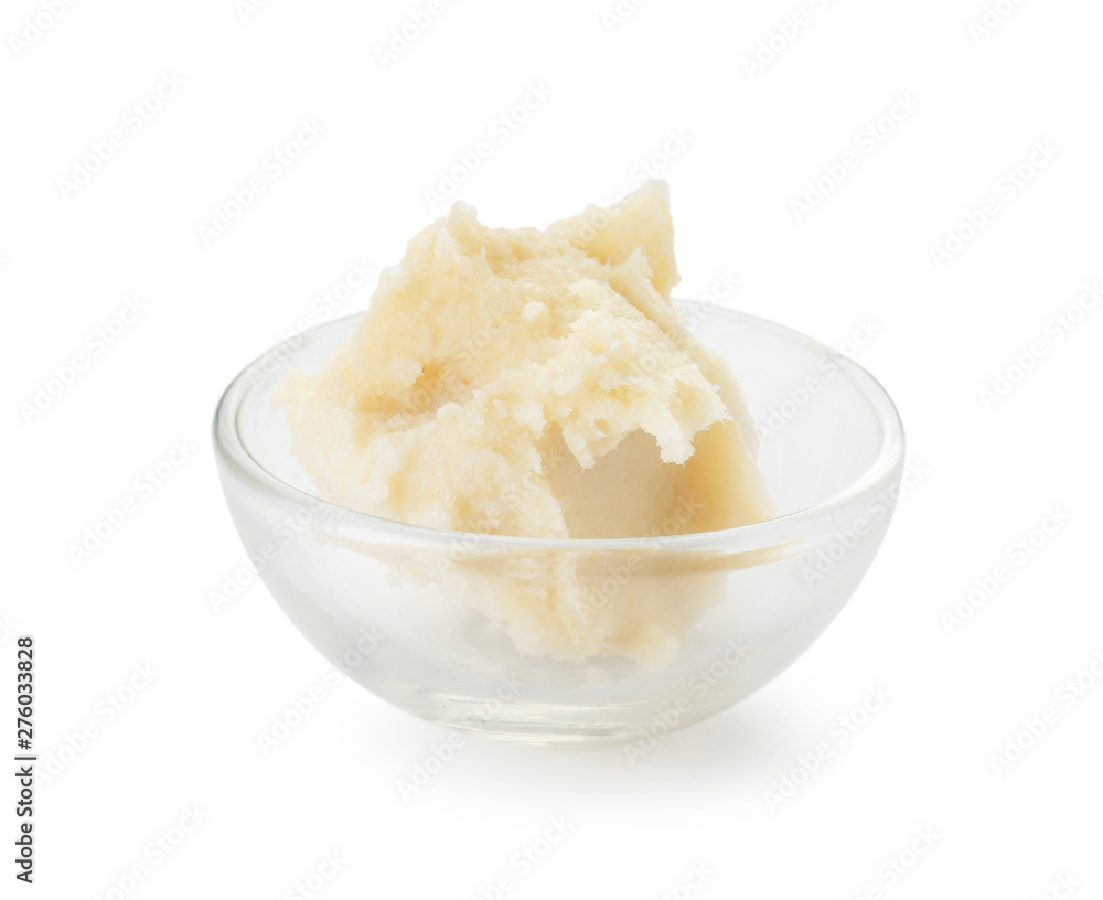 Bowl with shea butter on white background