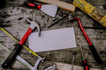 construction worker with drill. hammer and tools on wood planks with copy space. frame with copy space for your text or image