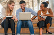 © Mongkolchon - business people have business brainstroming together outdoor on stair way with laptop computer tablet and book