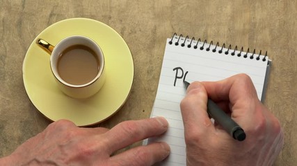 Canvas Print - podcast word (internet radio) - man hand writing a note with a black marker in a spiral notebook, ov