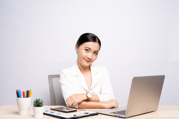 Portrait of a confidence woman sitting at office isolated over background