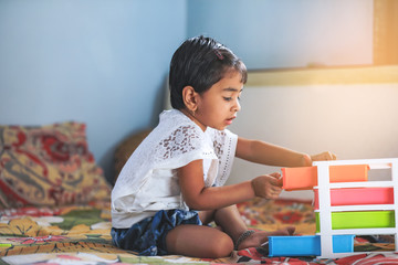 Wall Mural - young indian girl playing at home