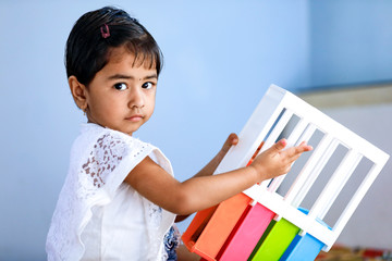 Wall Mural - young indian girl playing at home