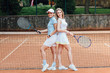 © Тарас Нагирняк - Beautiful female tennis players playing doubles at tennis at the tennis court..