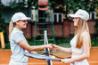 © Тарас Нагирняк - Happy girls playing tennis, shaking hands, smiling, spend time together..