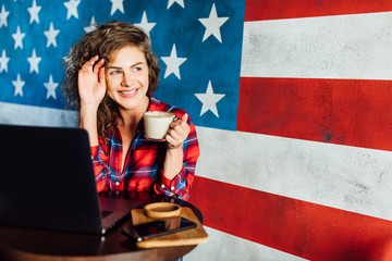 Happy young charming woman, working on laptop while sitting alone in restaurant at lunch, celebrating success ..