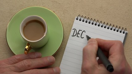 Canvas Print - declutter word - man hand writing a note with a black marker in a spiral notebook, overhead view