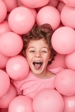 Excited Kid Playing In Balloons