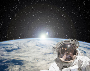 Wall Mural - Astronaut makes selfie against sunrise. The elements of this image furnished by NASA.