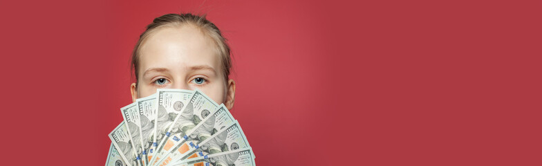 Wall Mural - Girl showing US dollars money cash on pink banner background