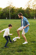 © Drobot Dean - Two cheerful brothers playing football on the lawn
