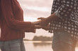 © StockPhotoPro - Romantic loving couple holding hands