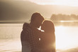 © StockPhotoPro - Romantic loving couple kissing at sunset