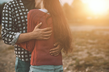young loving couple hugging outdoors