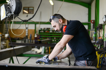 handsome man working in a workshop steel industry factory construction metallurgy machine site