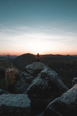 Fototapete - A tourist guy and beautiful morning sunrise of the Mariina Viewpoint, Bohemian Switzerland, National Park Bohemian Switzerland, Czech republic