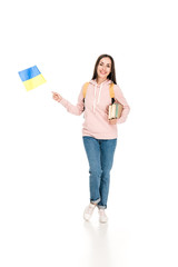 Wall Mural - full length view of smiling student with backpack holding Ukrainian flag and books isolated on white