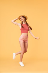 Poster - Young cheerful beautiful redhead woman posing isolated over yellow background.