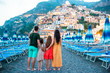 © travnikovstudio - Family in front of Positano on the Amalfi coast in Italy in sunset