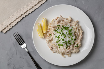 Wall Mural - Squid in sour cream sauce. Greek national dish. The view from the top. Copy-space.