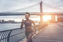Athlete Woman Training In The Morning At Sunrise In New York City, Brooklyn In The Background