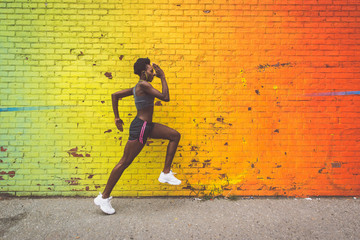 Athlete woman training in the morning at sunrise in New york city, Brooklyn in the background