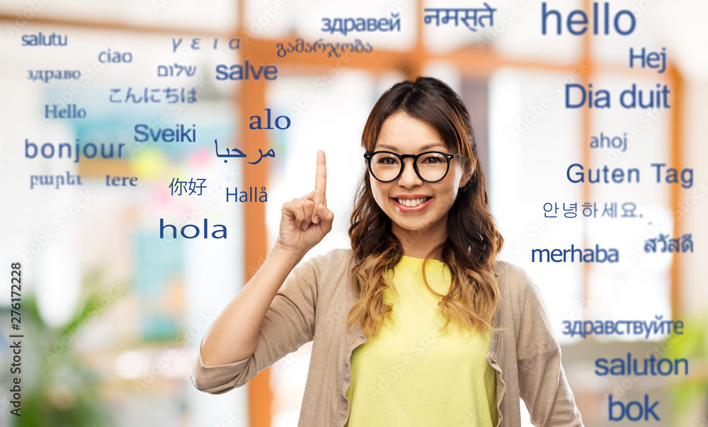 Foto translation, education and people concept - happy asian woman in glasses or stud