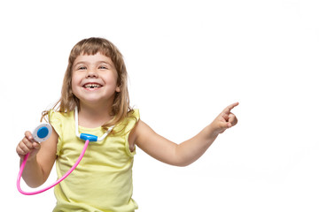 happy little girl, with a phonendoscope in hand, second hand indicates the place where the inscription may be, medicine and health concept, on a white background, isolate