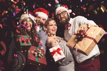 Wall Mural - Friends holding Christmas gifts