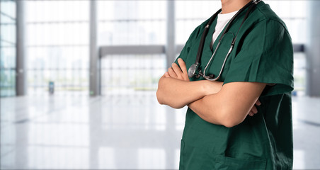 young doctor with hospital background