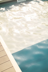 Hotel swimming pool with sunny reflections