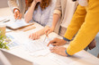 © pressmaster - Close-up of unrecognizable colleagues standing at table