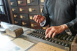 © DragonImages - Tradiotional Chinese medicine practitioner counting price of herbs on abacus