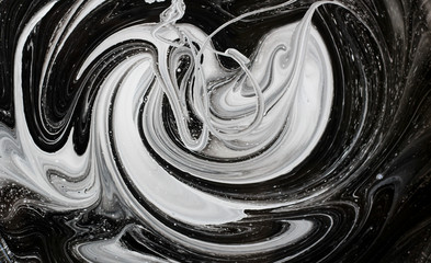 abstract image mixing of two colors. The texture of the circles of white and black paint