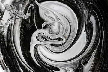 abstract image mixing of two colors. The texture of the circles of white and black paint