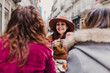© Eva - Three women friends having coffee in a terrace in Oporto, Portugal. Having a fun conversation. Lifestyle, tourism and holidays