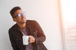 © kegfire - Cheerful black guy enjoying drink in morning