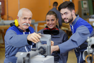 portrait of senior factory manager with apprentices