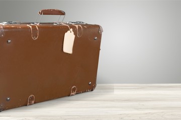 Retro suitcase with travel objects on wooden